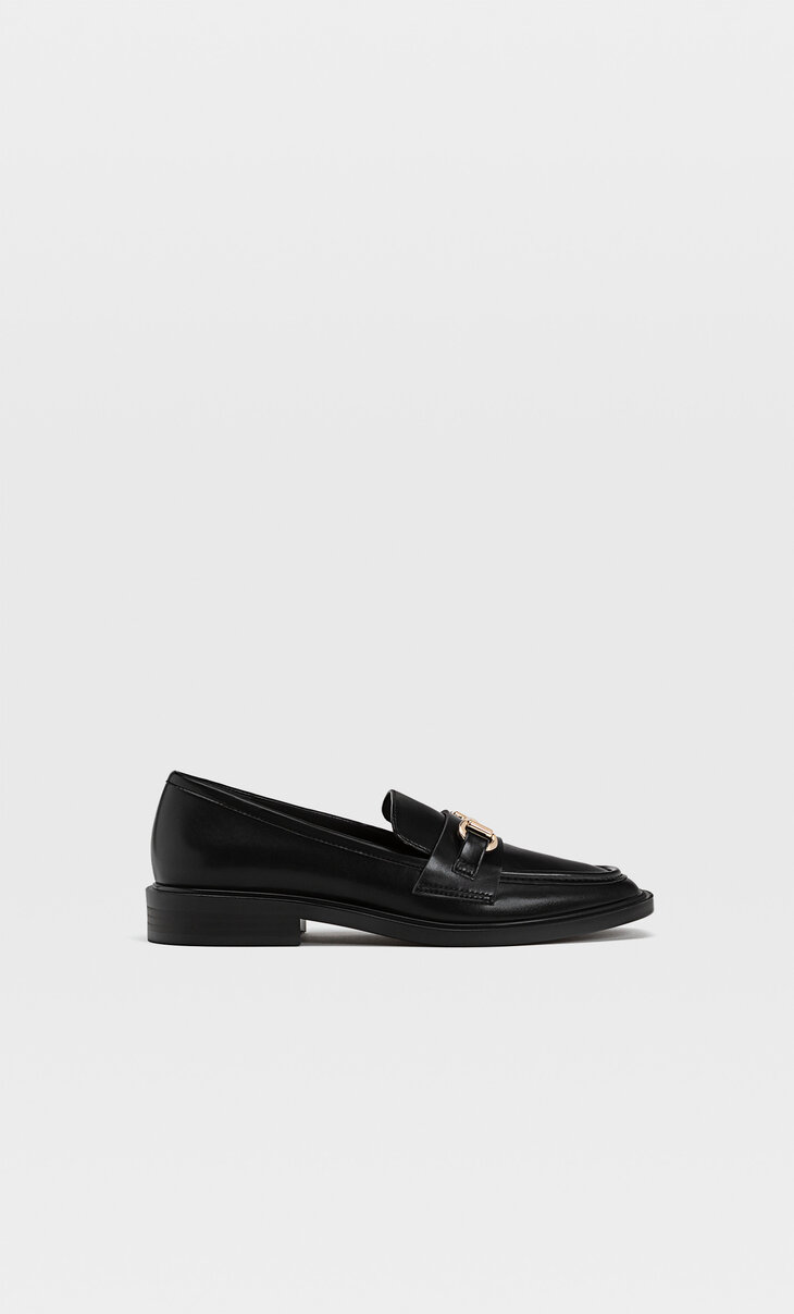 Black loafers with buckle detail