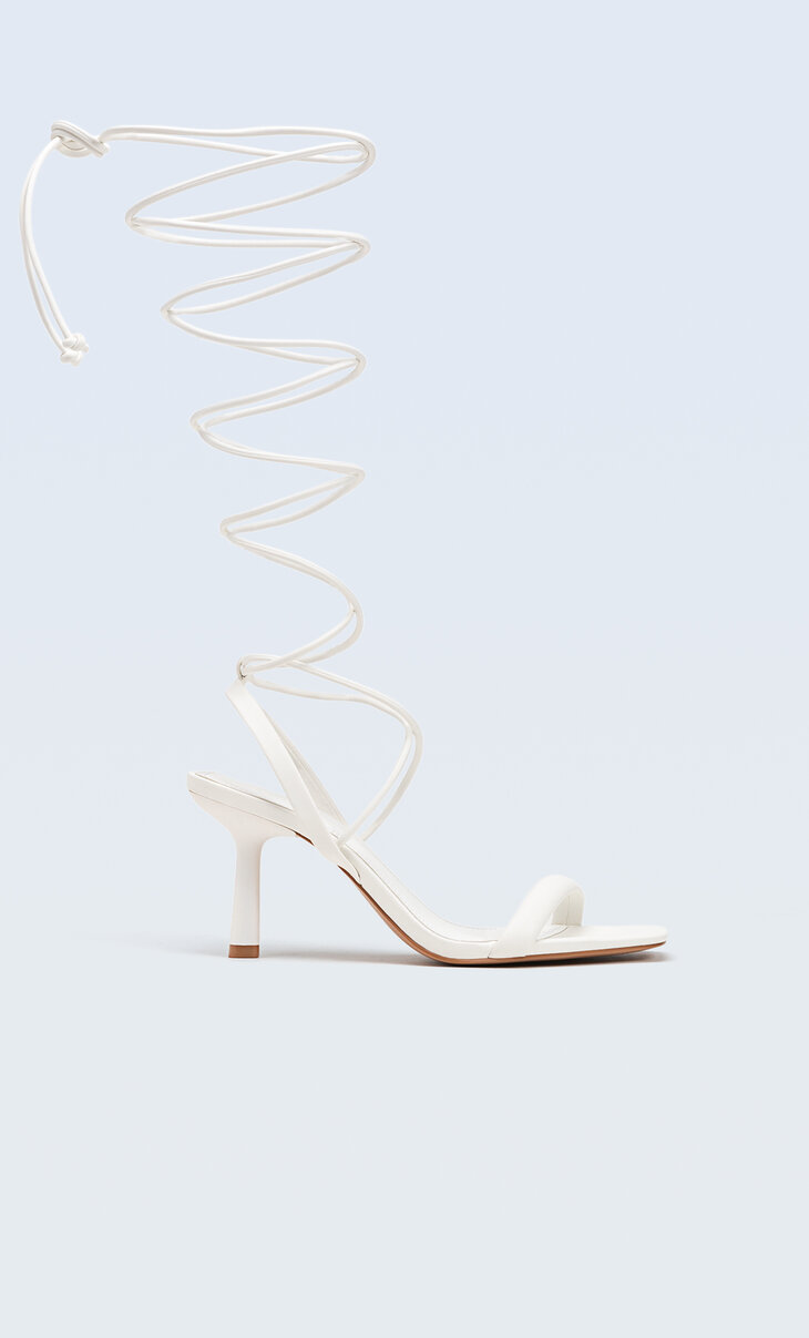 White heeled sandals with tied straps