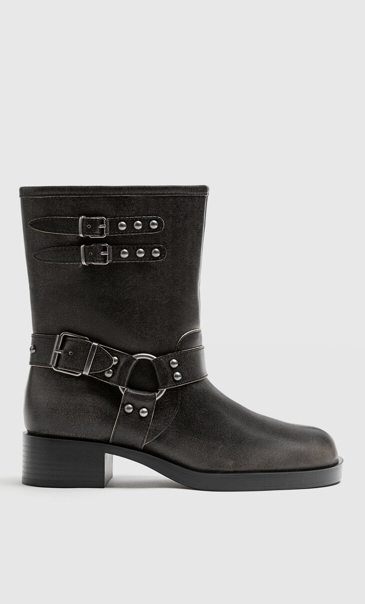 Flat distressed ankle boots with buckle details