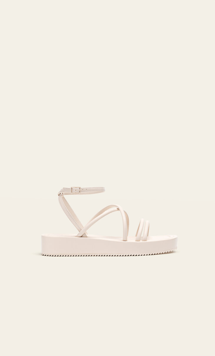 Flat sandals with tied straps