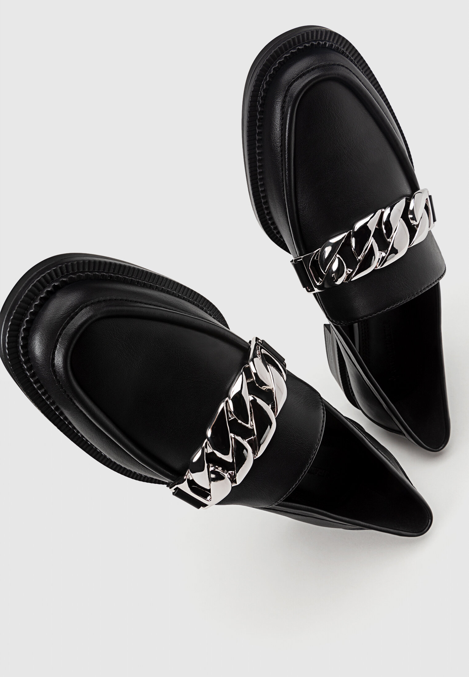 Black loafers with chain detail