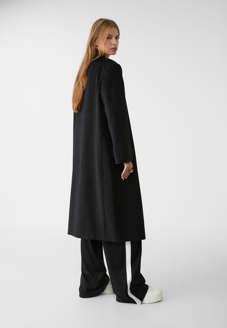 abrigo largo oversize bolsillos