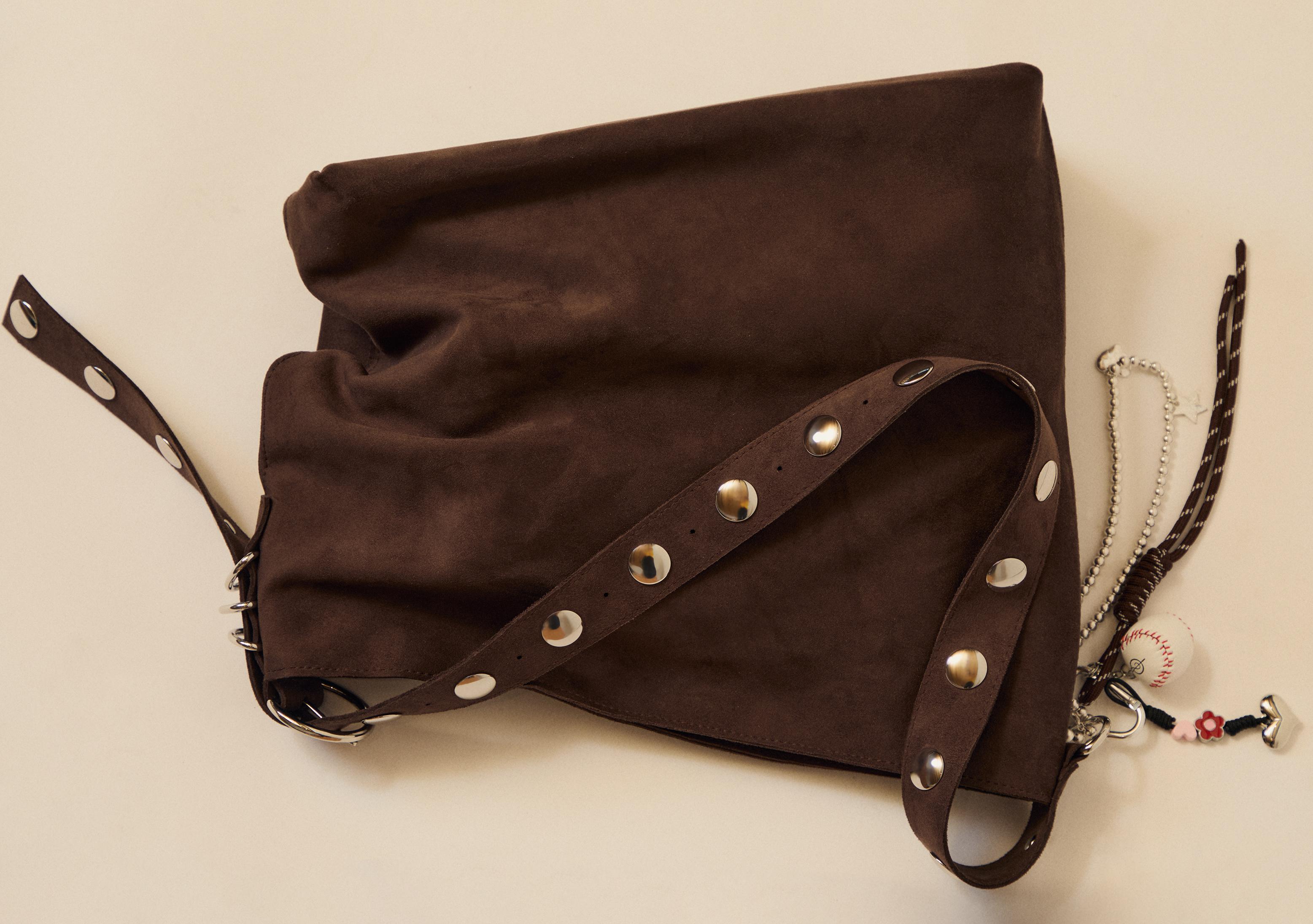 Faux suede bucket bag with strap detail — Brown