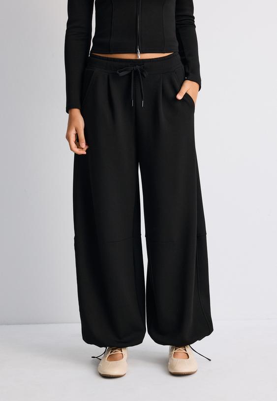 calcas jogger barrel de toque suave com stoppers