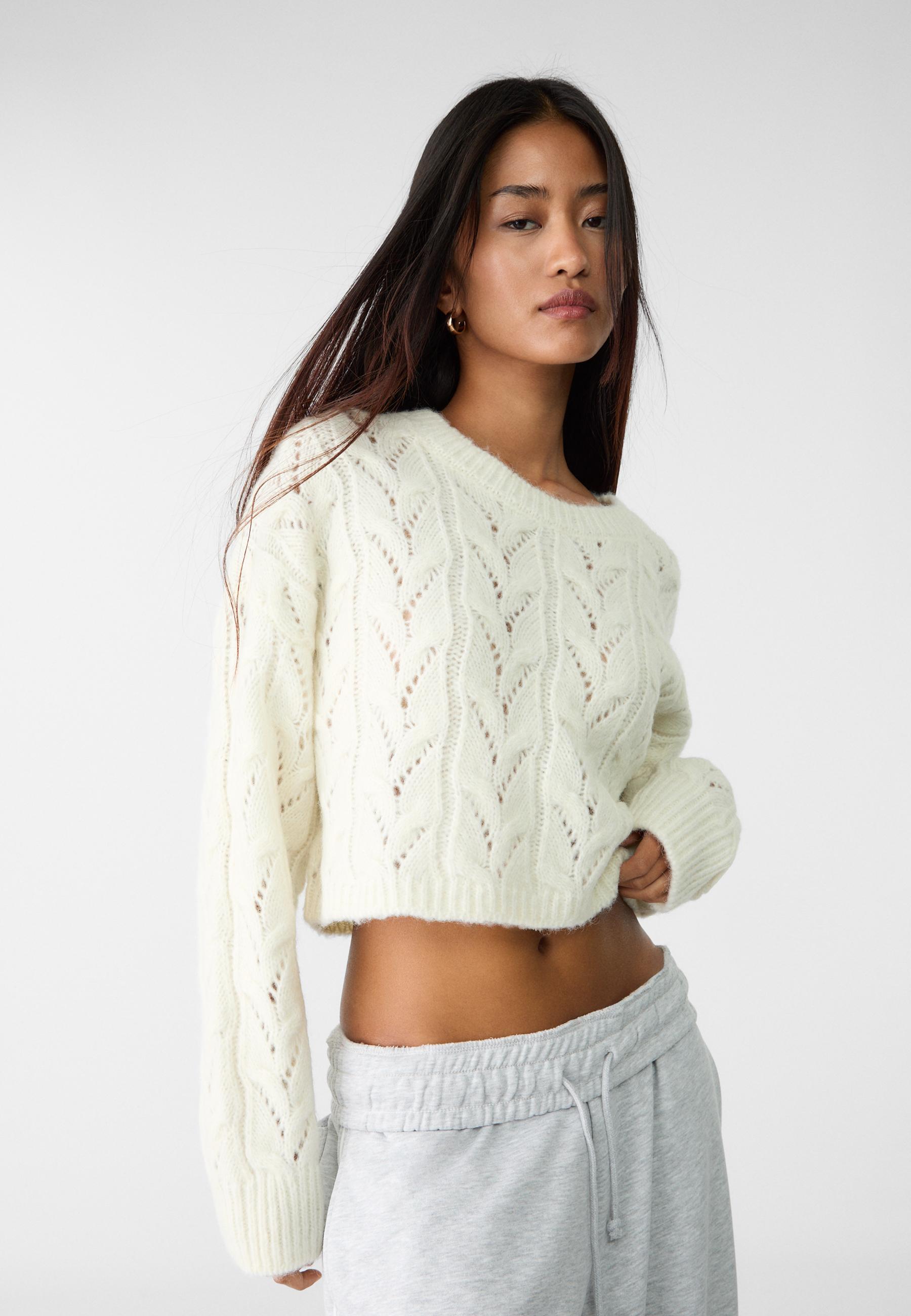 Cropped cable knit sweater