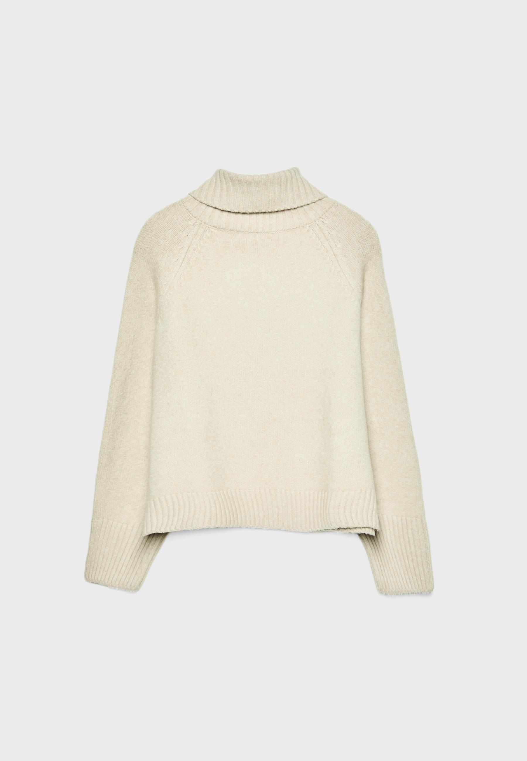 Front view of a chunky knit beige sweater with a high neck and long sleeves.