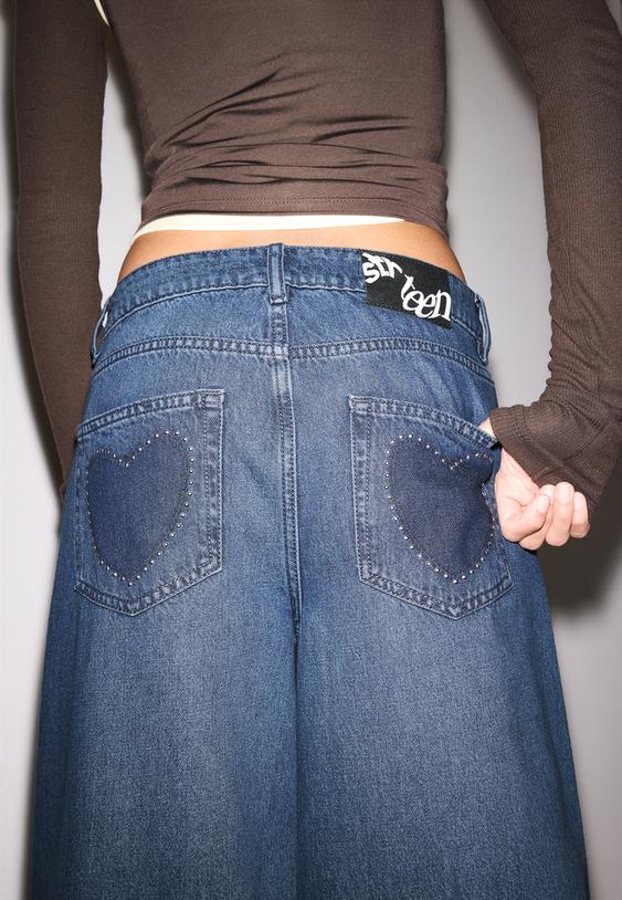 jeans wide leg tachas corazon