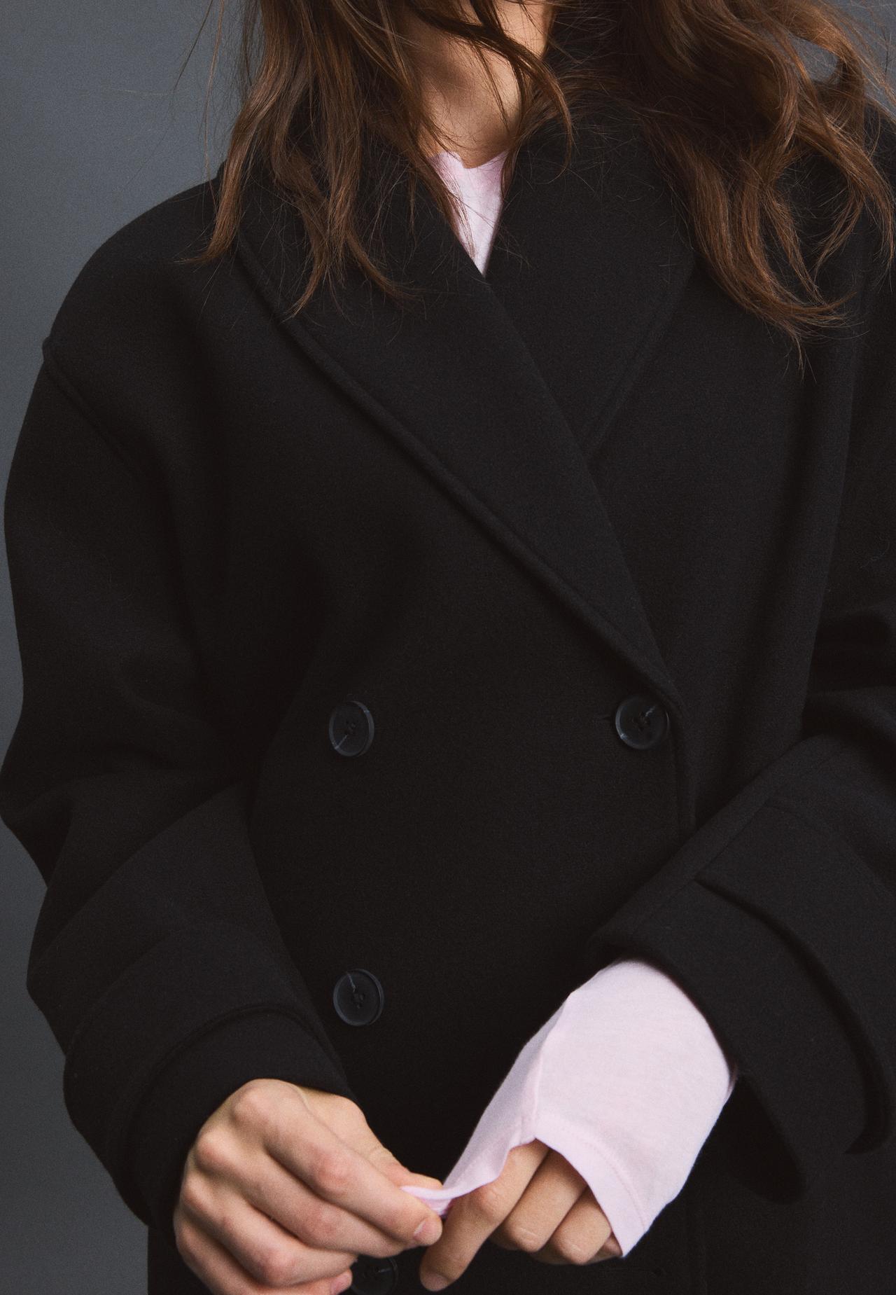 Soft-touch crossover high neck jacket — Black