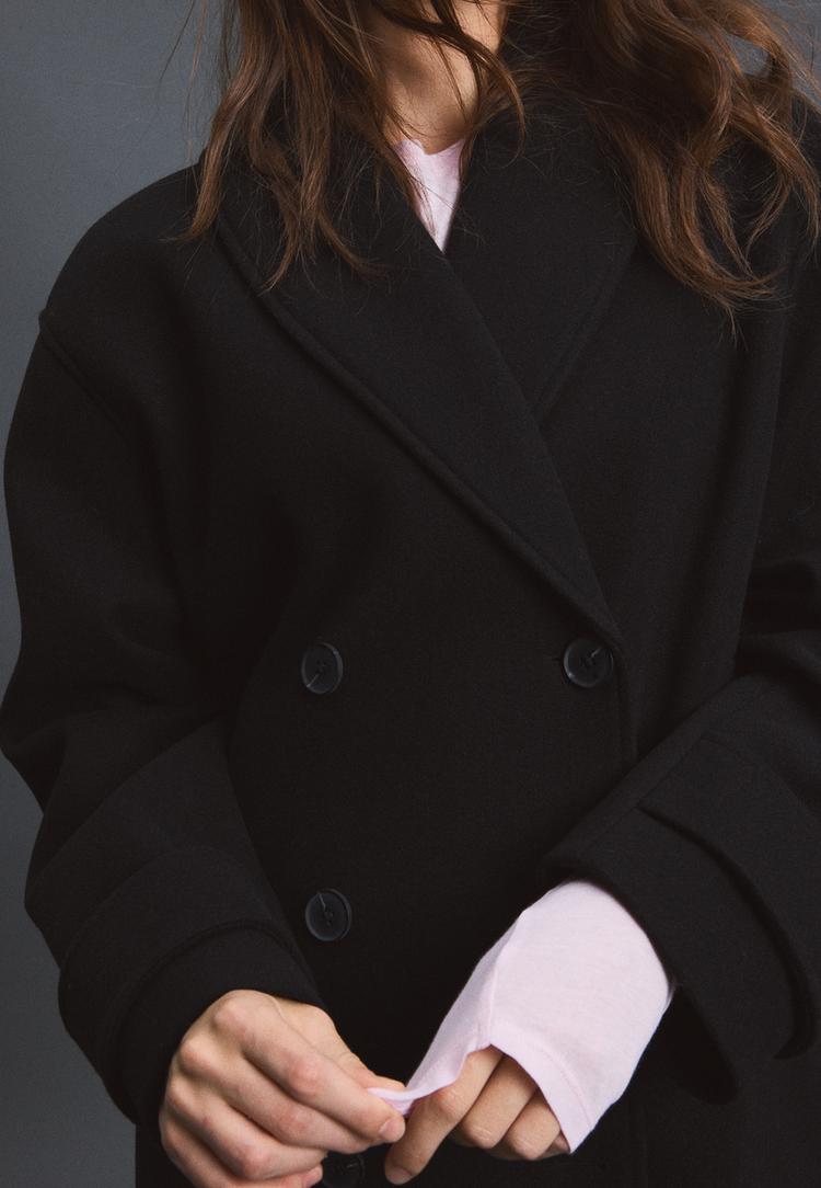 Soft-touch crossover high neck jacket — Black