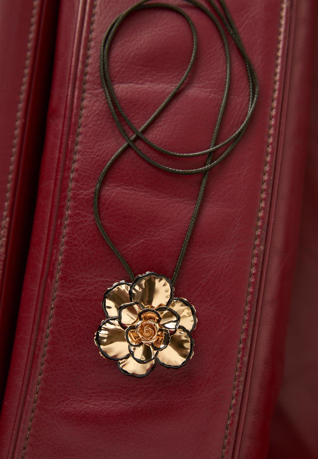 Cord necklace with metal flower