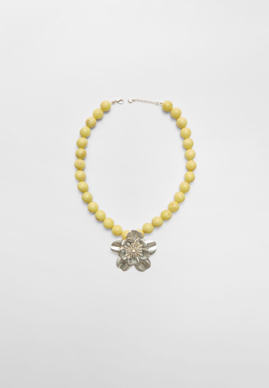 Beaded necklace with metal flower