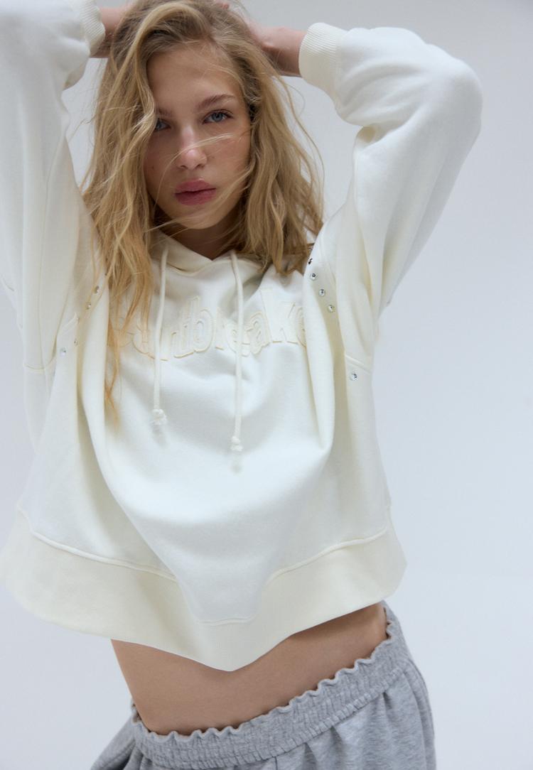 sweater met capuchon borduursel en studs