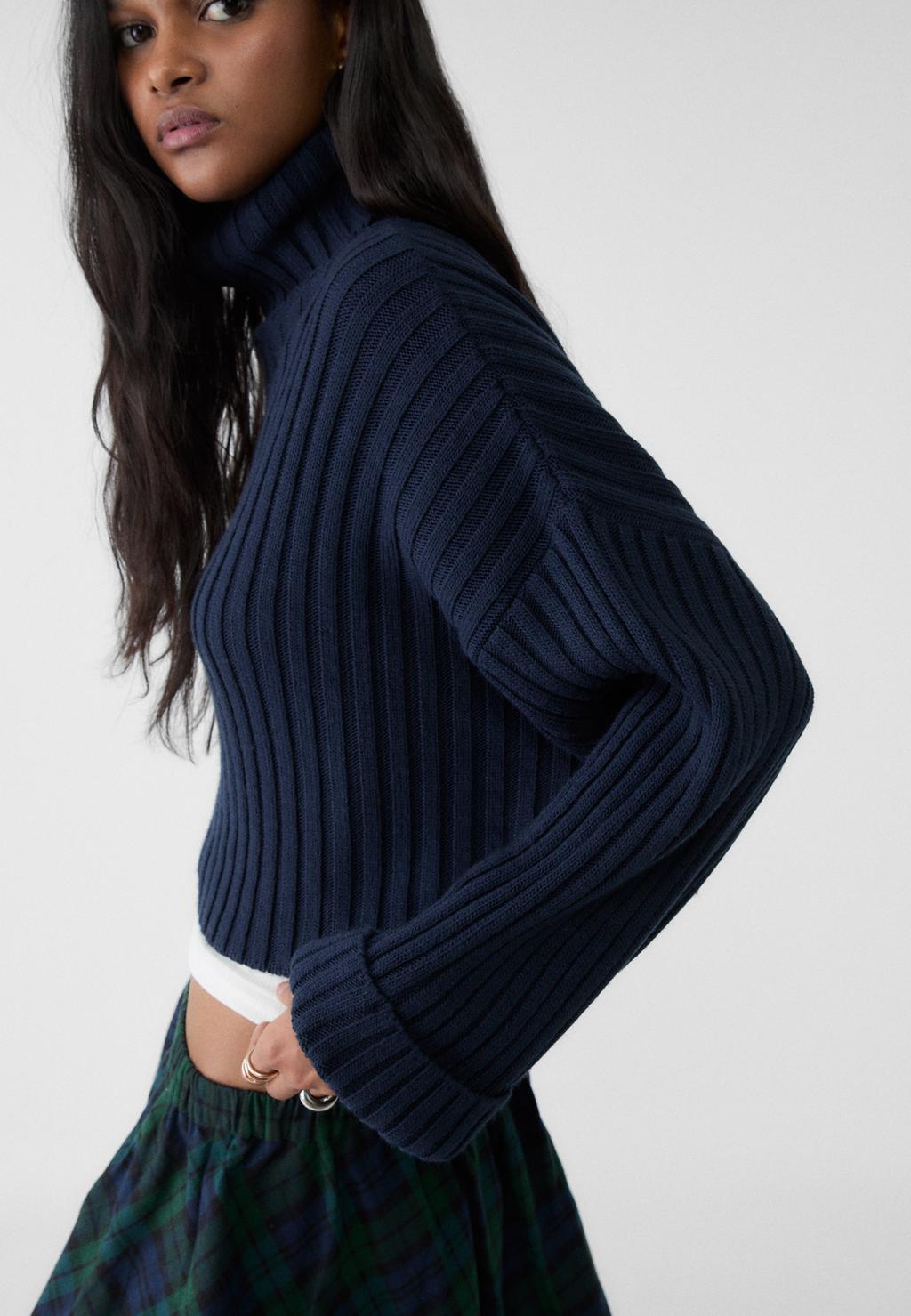 Knit jumper with raised neck