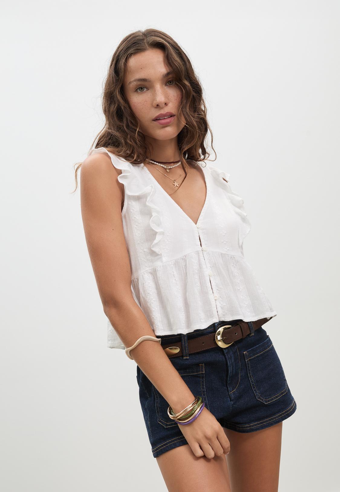 Loose-fitting embroidered top with ruffles