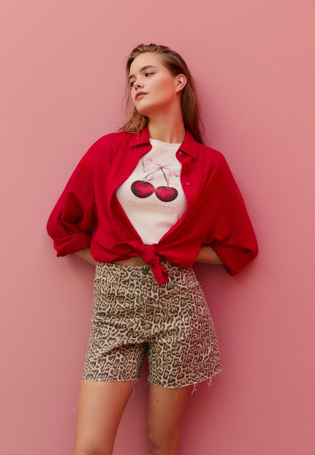 Longline leopard print denim shorts