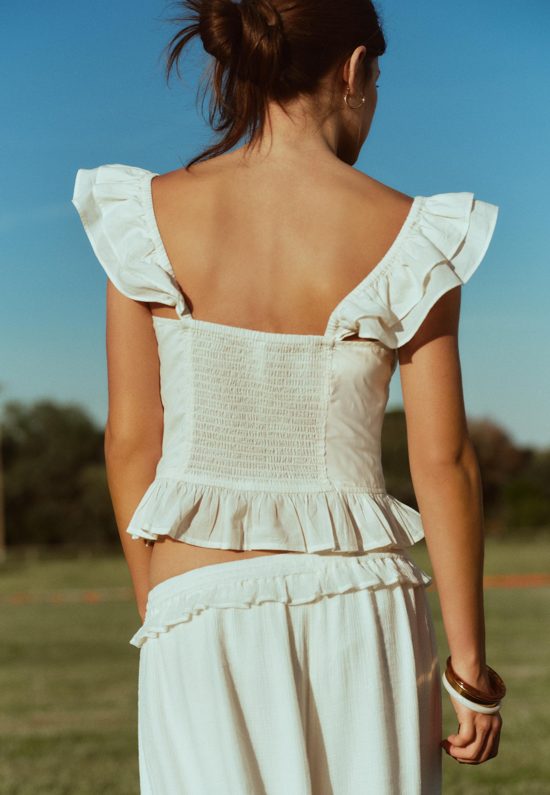 Ruffled corsetry-inspired top — Ecru