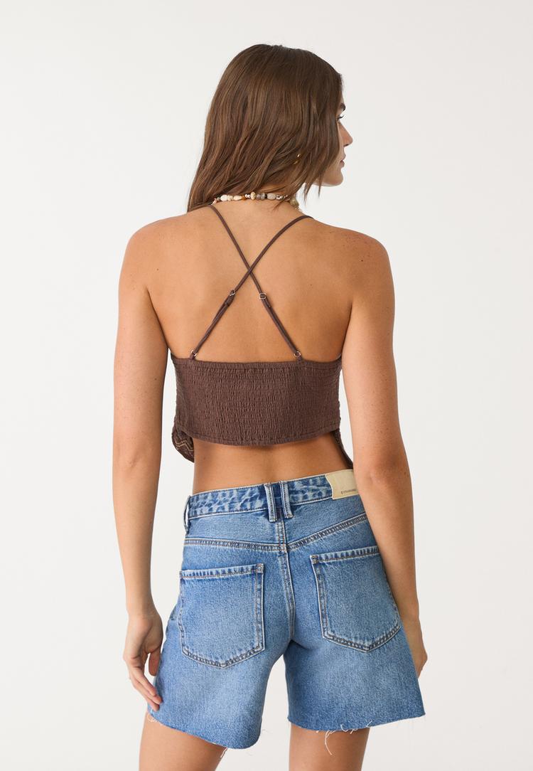top met borduursel en bandjes