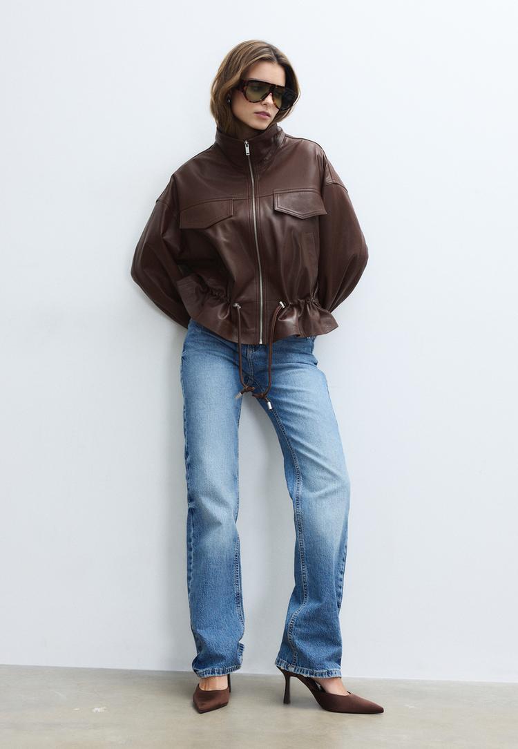 blouson avec poches et ajusteur en cuir