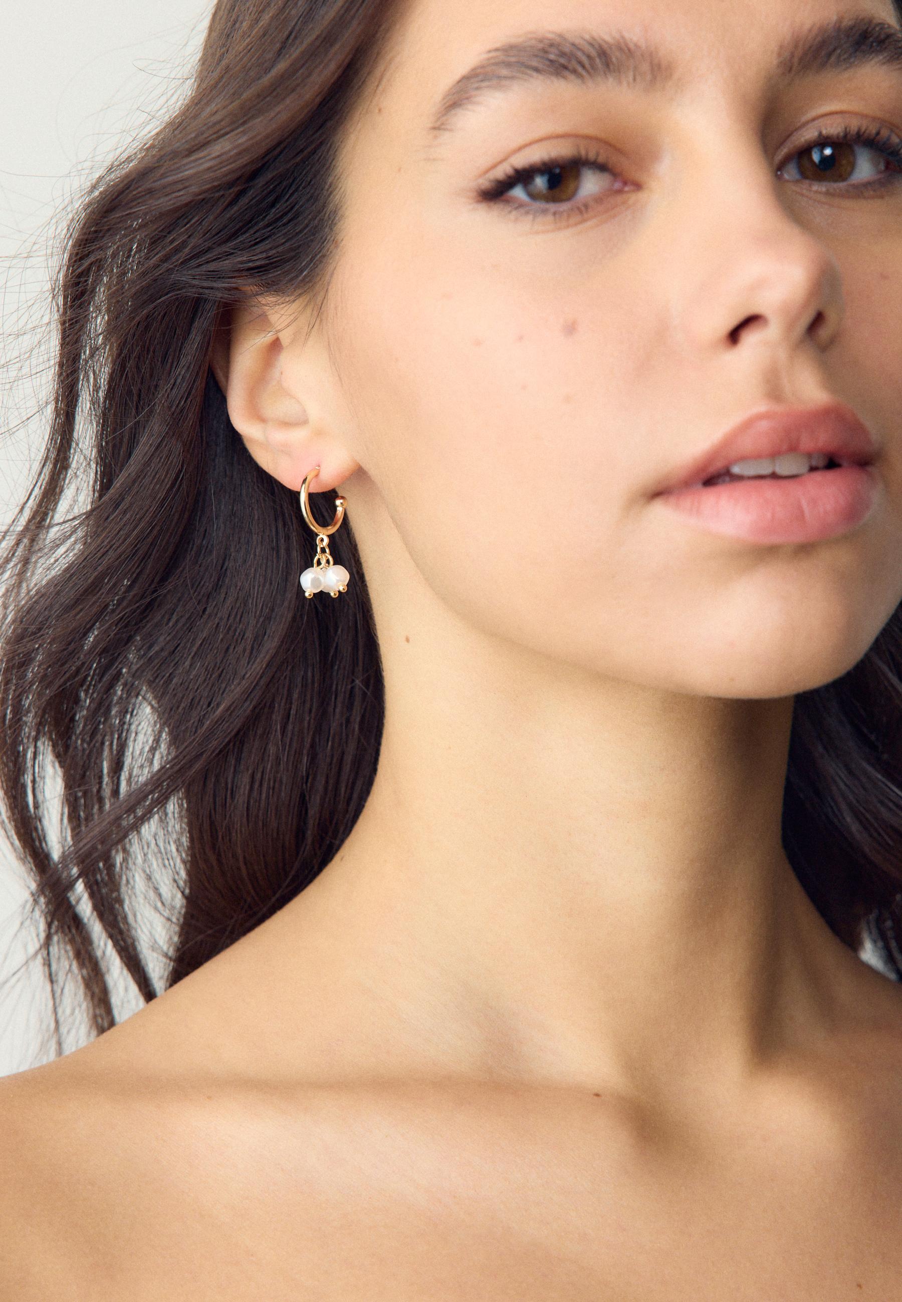 9-pack of ladybird earrings — Gold