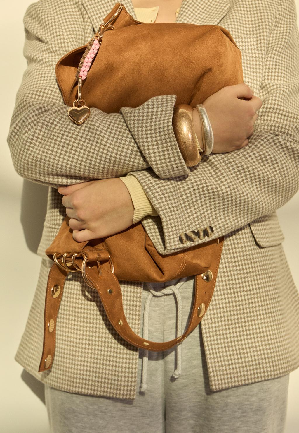 Faux suede bucket bag with strap detail