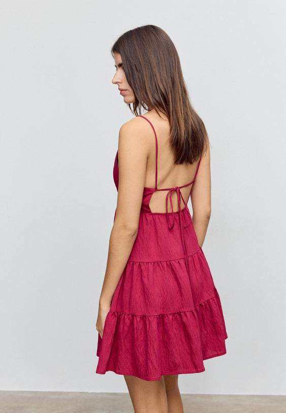 short flowing dress with tied detail at the back