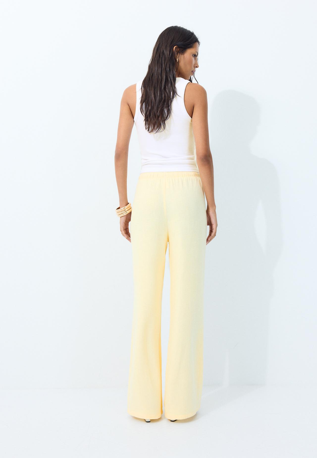 Flowing linen-effect trousers — Pastel yellow