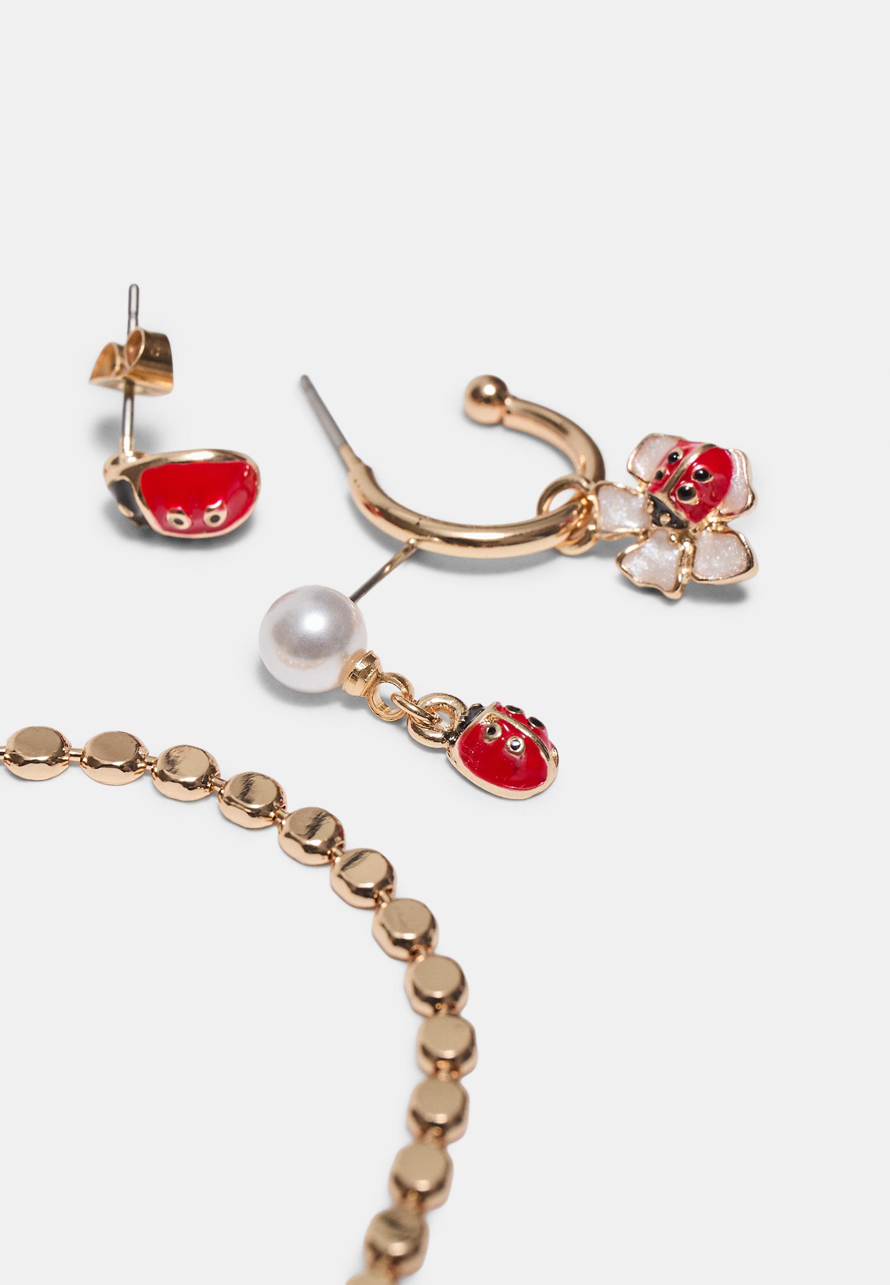 9-pack of ladybird earrings — Gold