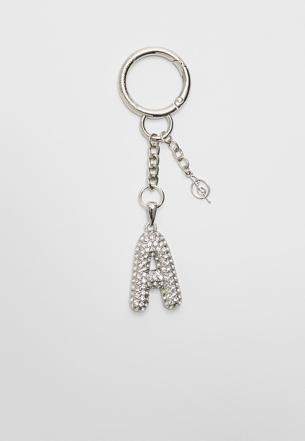 Key ring featuring an initial charm with rhinestones