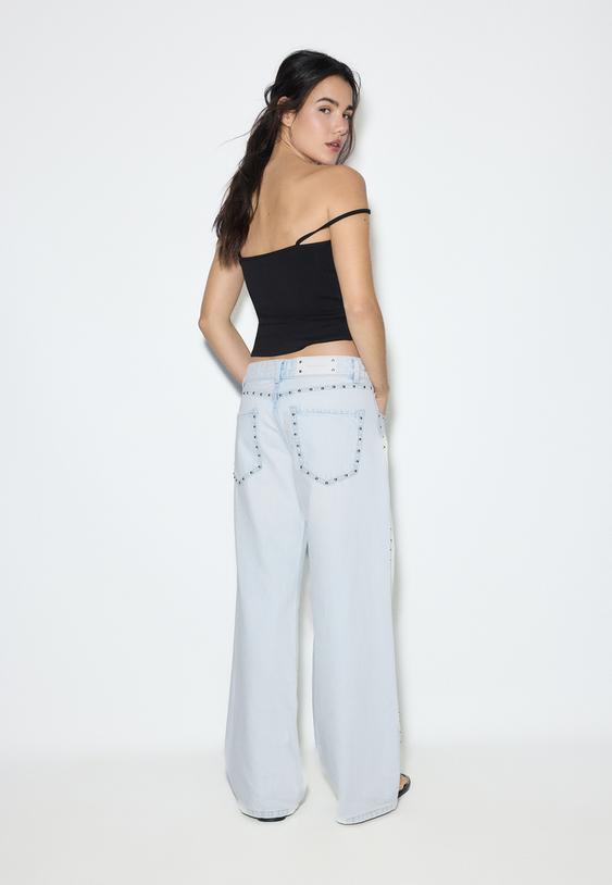 jeans wide leg soltos com tachas