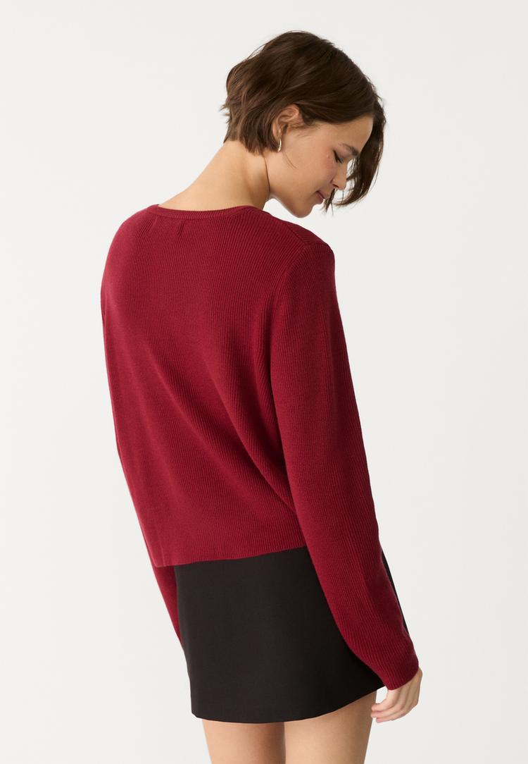 veste en maille a boutons et bord cote