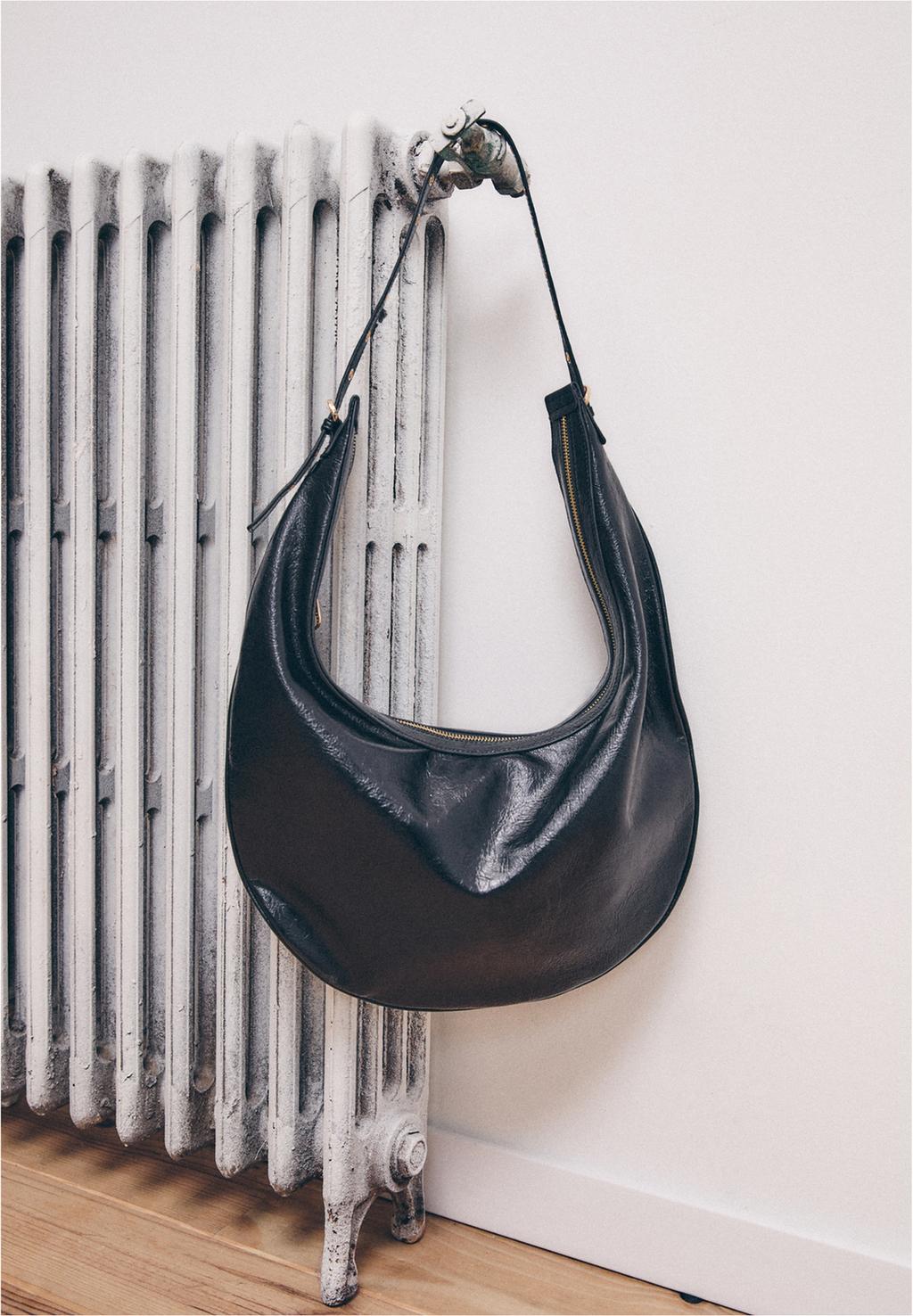 Half moon bag with detailed strap