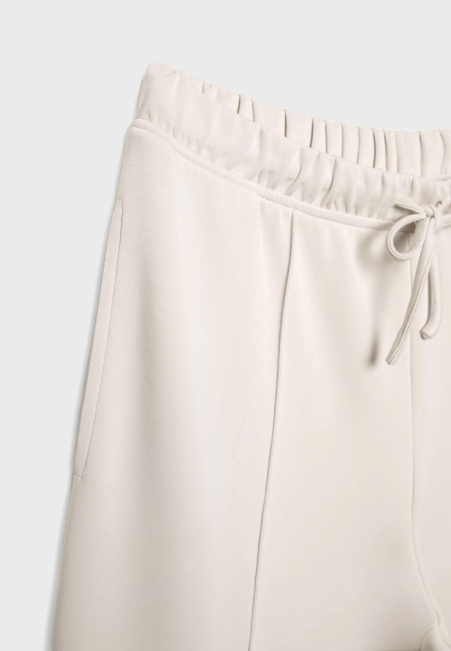 Soft-touch wide-leg pin-tuck joggers — Stone